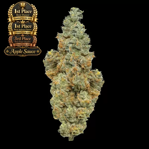 Gold '1st Place' Cannathlon 2026 award badge beside a dense, frosty cannabis bud on a black background, indicating the product's prize.