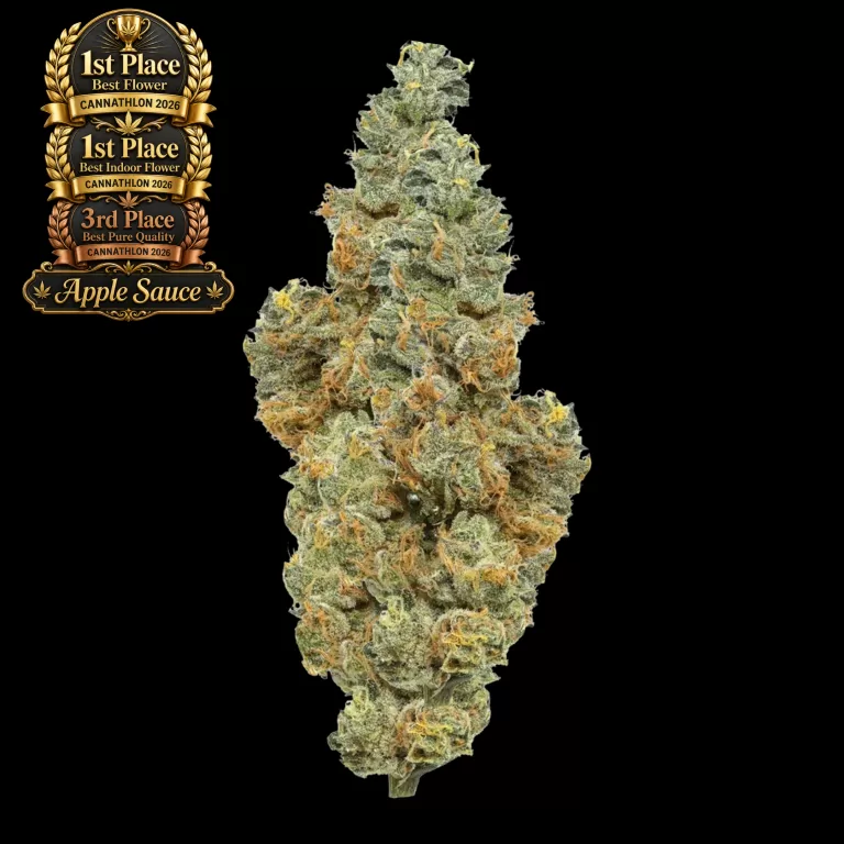 Gold '1st Place' Cannathlon 2026 award badge beside a dense, frosty cannabis bud on a black background, indicating the product's prize.