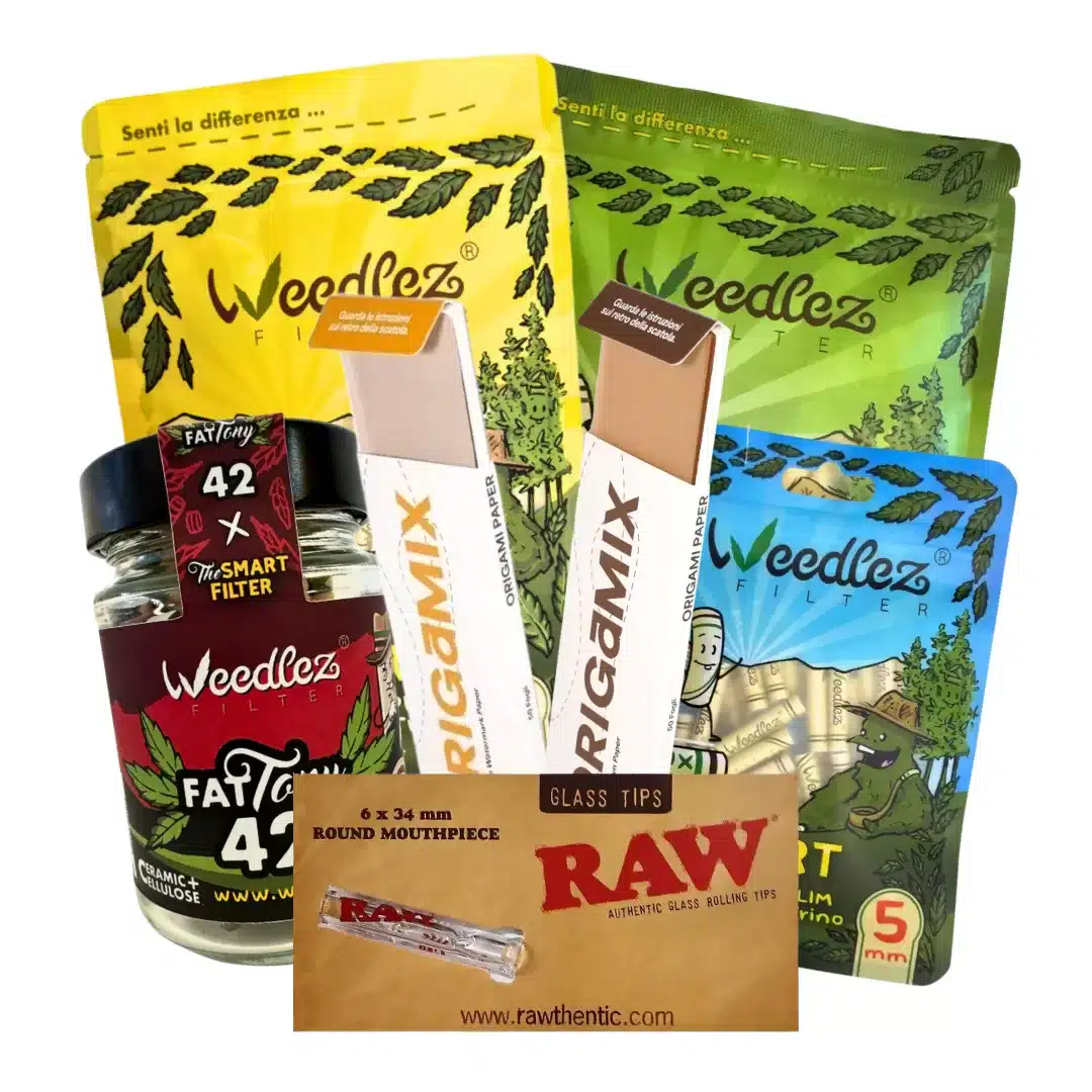 Assorted cannabis rolling papers, filters, and accessories, including two white paper cartons, a RAW glass tips card, a red WeedEZ grinder, and colorful pouches in yellow, green, and blue behind them.