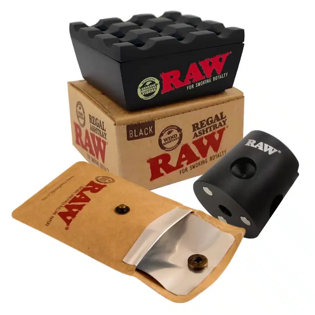 RAW brand smoking accessories: a black multi-hole ashtray resting on top of RAW packaging and boxes.