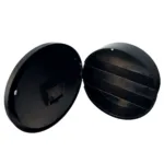 Two black round metal lids opened apart, exposing internal horizontal slats like grill racks.