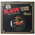 Packaging for RAW Stash Clock Black, featuring a round wall clock with a yellow-number dial and the red RAW logo.