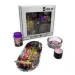 Colorful 5-piece smoking accessory set with a decorative tray, grinder, jars, and storage containers in front of a branded box.